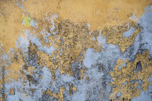 Chipped yellow wall texture with mold and mildew