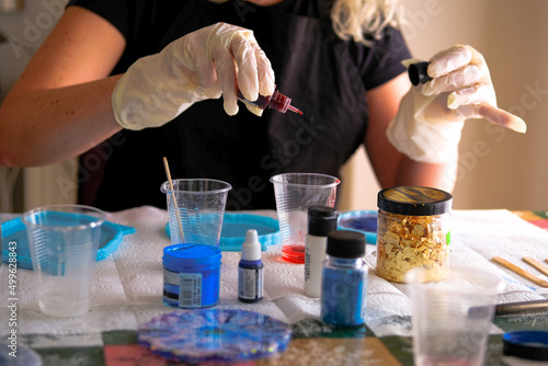 Woman making epoxy resin arts and crafts. photo