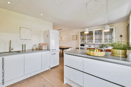 Kitchen with two countertops and food on them next to a refrigerator photo