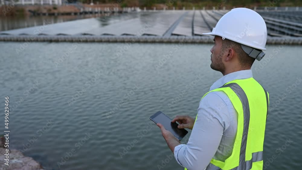 Asian engineer working at Floating solar farm,Renewable energy,Technician and investor solar panels checking the panels at solar energy installation Asian engineer working at Floating solar farm,Renewable energy,Technician and investor solar panels checking the panels at solar energy installation