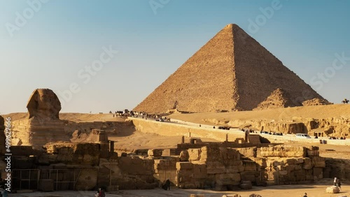 Daily life in complex or necropolis near Giza pyramids and Great Sphinx. Timelapse. Tourists see landmarks of ancient Egypt on horseback, camels, cars, buses photo