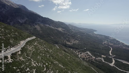 drone video over the Llogara mountain pass on SH8, Albania. Front shot over the Maja e Cikes mountains, in the town of Palase. photo