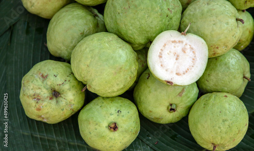 slice fresh guava and organic fruite on green