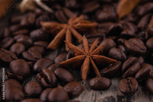 chocolate, cinnamon sticks and coffee beans on wooden background