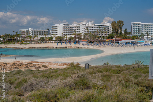 Nissi Beach in Ayia Napa, clean aerial photo of famous tourist beach in Cyprus, the place is a known destination on island and is formed from a smaller island just near the main shore © SAndor