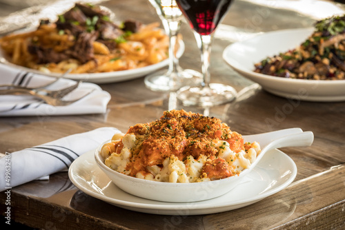 Buffalo Chicken Mac and Cheese with Red Wine on a Table photo