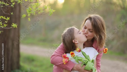 mother hugs and kisses daughter. mothers Day