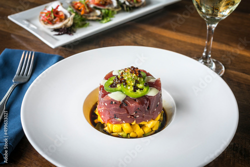 Ahi Tuna Tartare on a White Plate and Wooden Table 