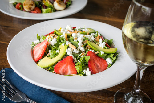 Strawberry and Avocado Salad with Feta Cheese and White Wine on a Wooden Table