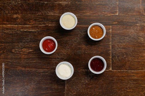 five sauces for every taste on a wooden background