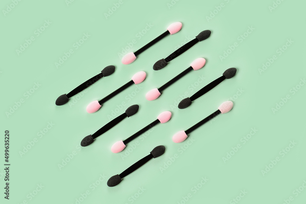 Set of applicators for shadows on green background. Shadows and eye makeup. Application of eyebrows. Set of applicators for shadows on green background. Shadows and eye makeup. Application of eyebrows.