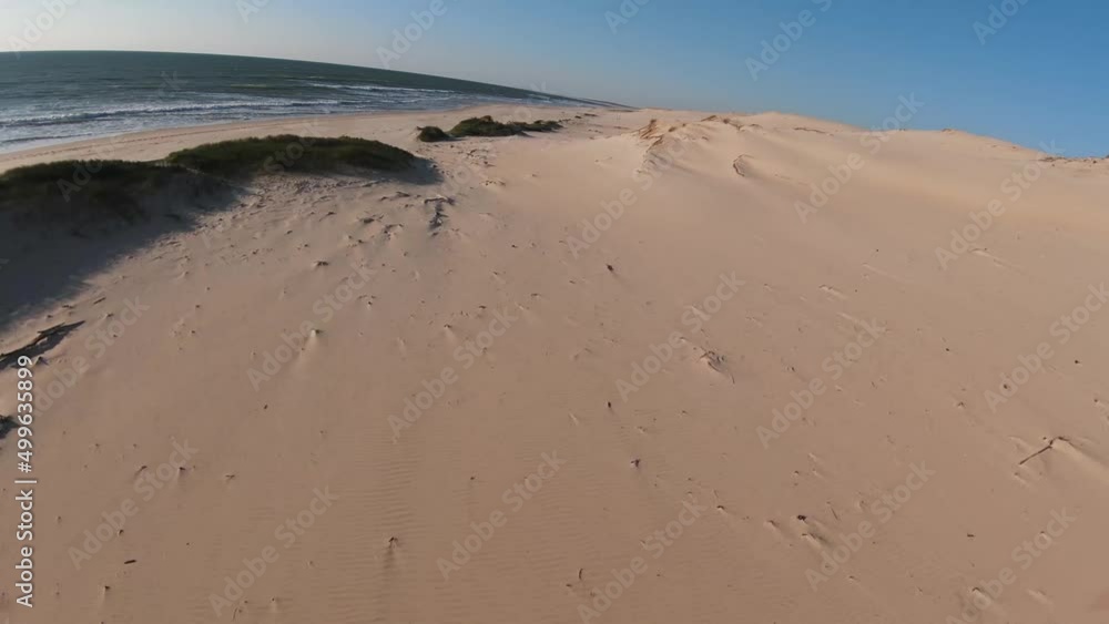 Fences buried on the sand dunes at Vivier beach in Biscarrosse western France, Aerial drone flyover low racing shot Fences buried on the sand dunes at Vivier beach in Biscarrosse western France, Aerial drone flyover low racing shot