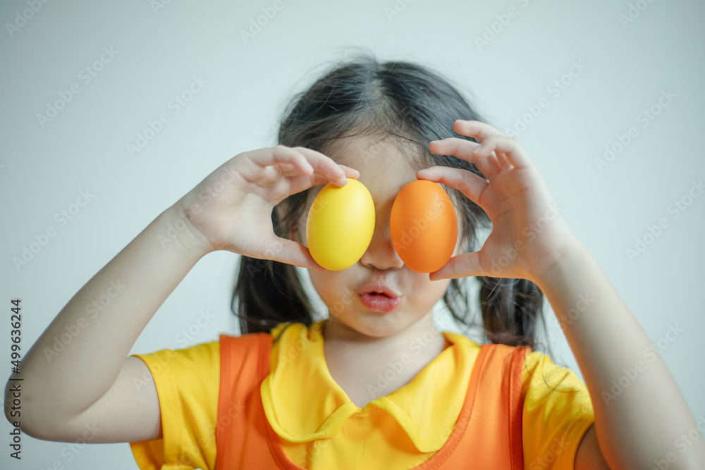 Happy woman smiling and holding colorful Easter eggs front eyes. Happy woman smiling and holding colorful Easter eggs front eyes.