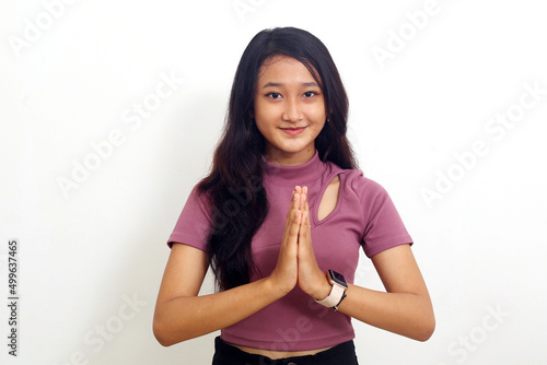 Asian girl standing with hands clasped looking at camera. isolated on white background