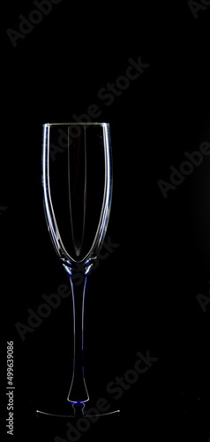 A glass of young wine on a black background.