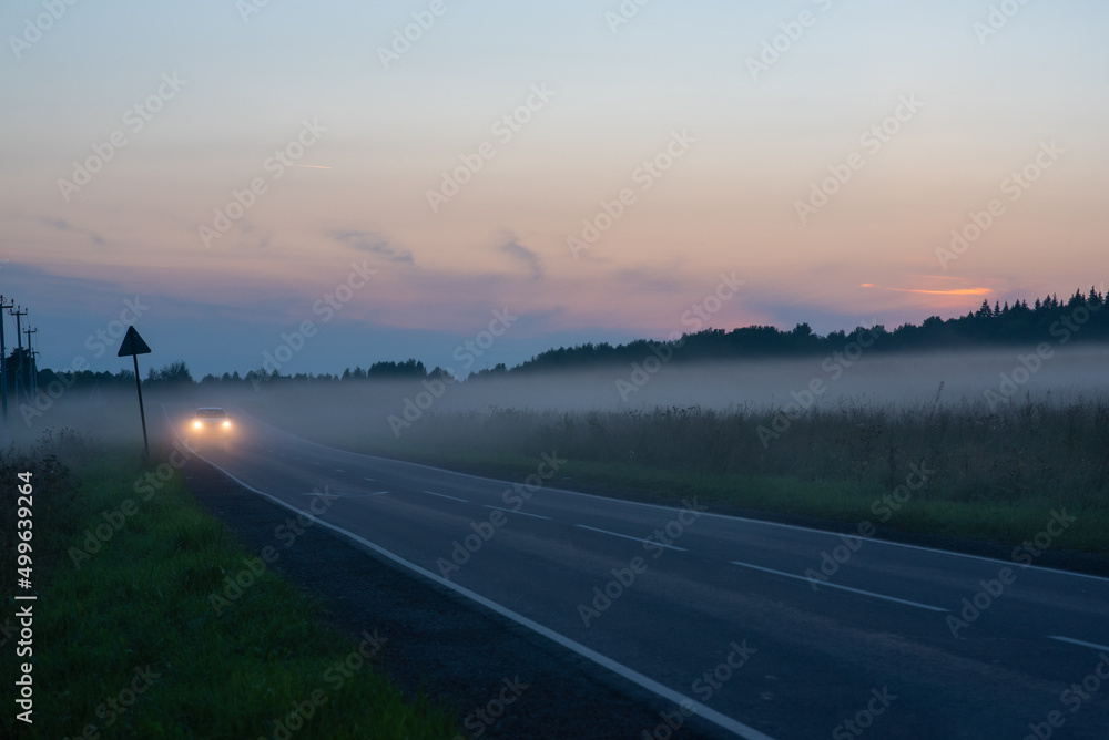 Car on the road in the fog