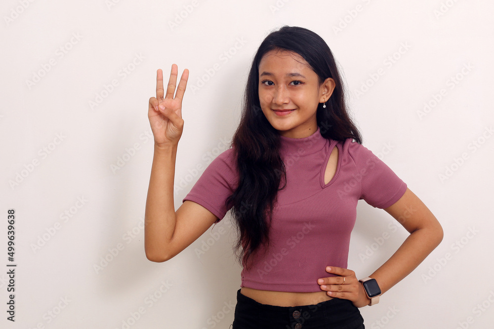 asian girl pointing up three hand with finger on upper side with smile face asian girl pointing up three hand with finger on upper side with smile face