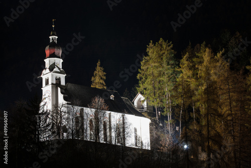 High above the small village of Rietz in Tyrol, shines illuminated by headlamps the pilgrimage church    to the Saint Anthony of Padua through the night and is visible from afar for everyone. photo