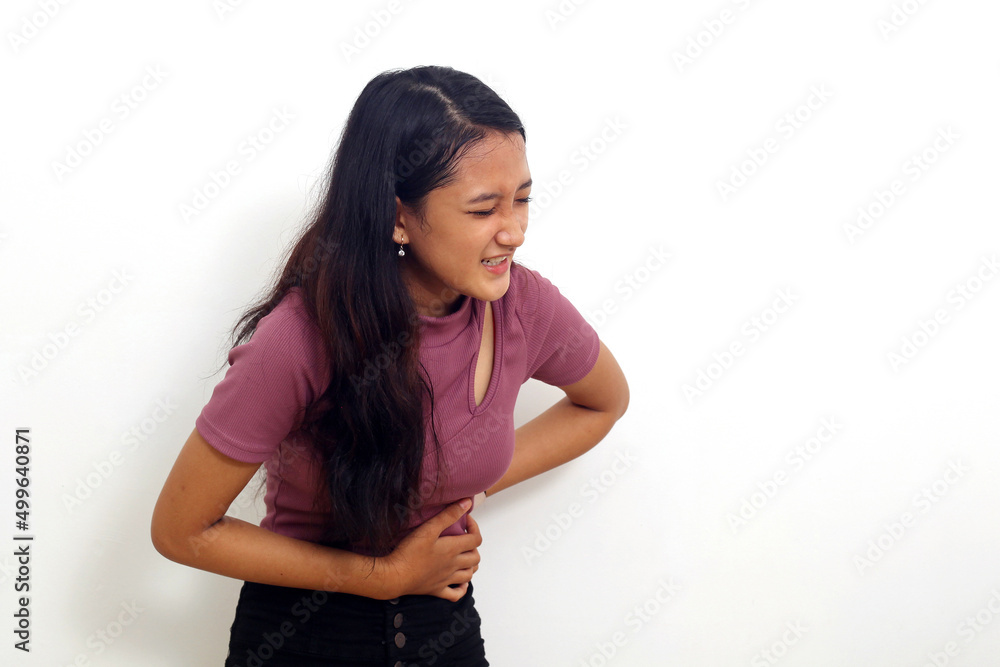 Asian beautiful young woman has stomachache, female abdominal pain suffering from stomach ache Asian beautiful young woman has stomachache, female abdominal pain suffering from stomach ache