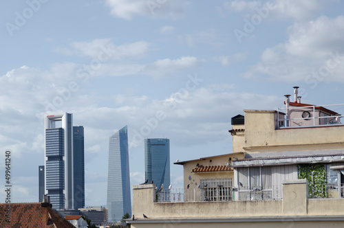 Urban scene with old buildings in city and skyscrapers in Madrid