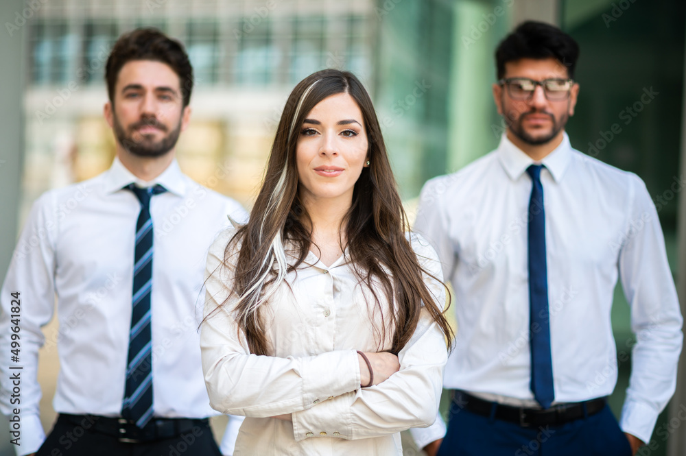 Business team smiling outdoor in a modern urban setting Business team smiling outdoor in a modern urban setting