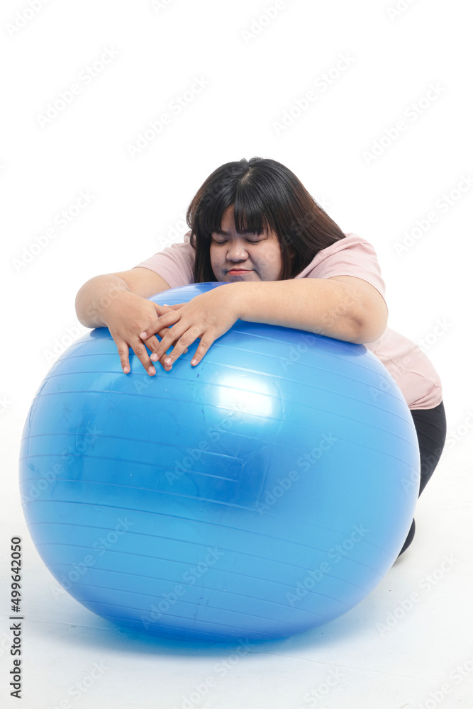 fat woman tired from exercise She was leaning on a blue yoga ball. White background. Weight loss exercise concept. health care fat woman tired from exercise She was leaning on a blue yoga ball. White background. Weight loss exercise concept. health care