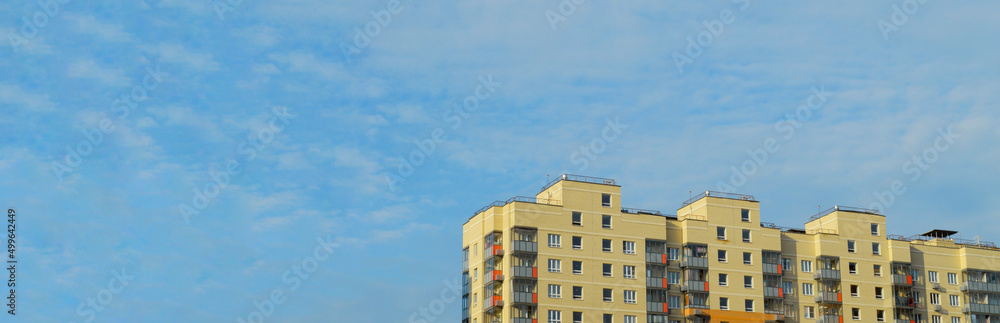 Identical high-rise buildings. Same type apartment buildings against a blue sky