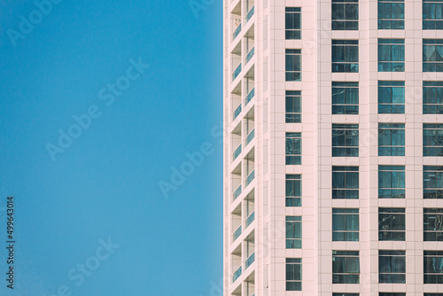Wall With A Balcony Of New Empty Modern Multi-storey Residential Building House In Residential Area On Sunny Blue Sky. Close Up.