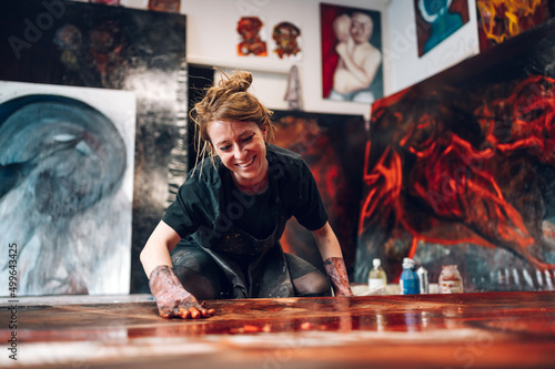 Female painter artist painting and creating her art in a creative studio photo
