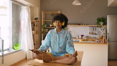 Beautiful young woman with curly afro hairstyle living in her cozy loft apartment. Hispanic girl lifestyle moments.