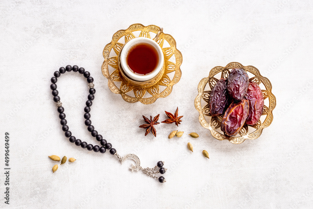 Turkish tea on Ramadan with islamic rosary and dates fruits in bowl Turkish tea on Ramadan with islamic rosary and dates fruits in bowl