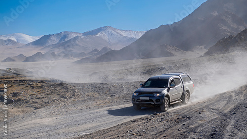 pickup truck driving through dusty terrain in Mongolia photo