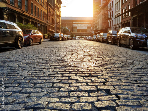 Fototapeta Old cobblestone street with cars parked along the curb in the Tribeca neighborho