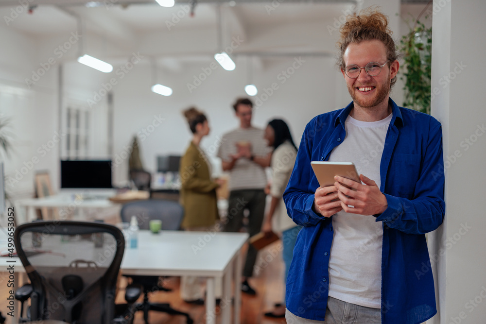 Fototapeta premium Young businessman using digital tablet in the office