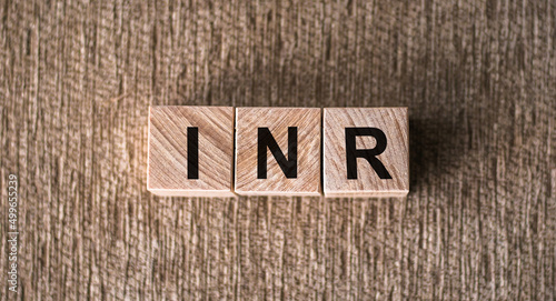 INR - International Normalized Ratio acronym on cubes on wooden surface. Medical concept. photo