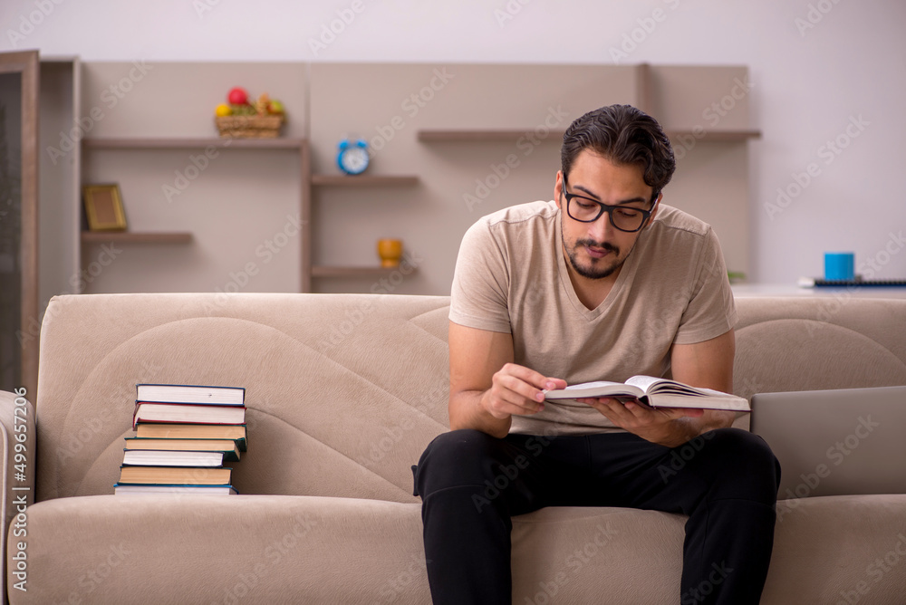 Young male student studying at home during pandemic Young male student studying at home during pandemic