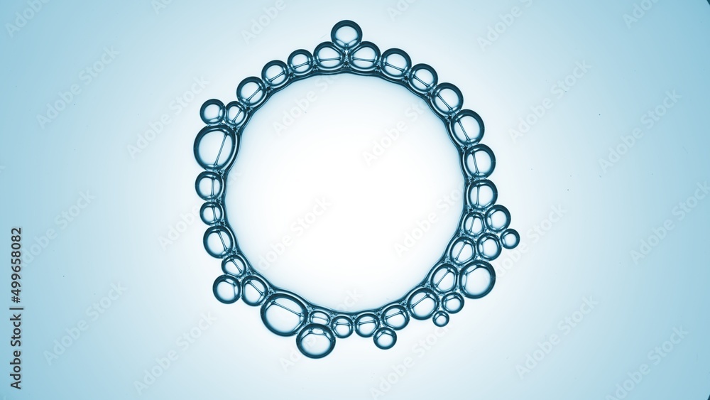 Obraz premium Macro shot of big transparent bubble with small ones connected around it on blue radial ramp background | Abstract skin care cosmetic ingredients concept