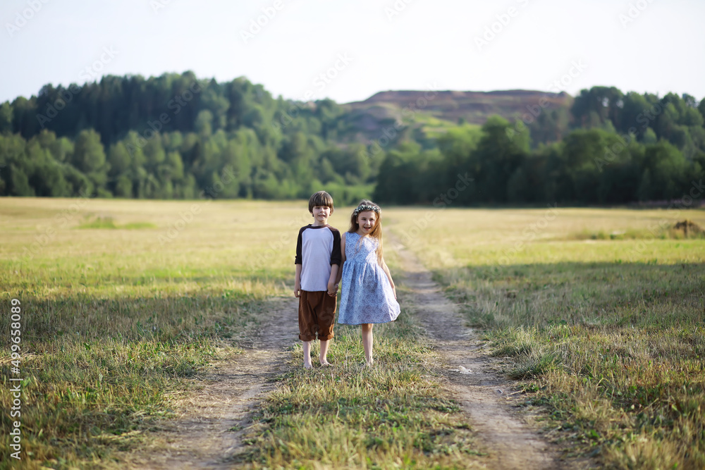 Children walk in the summer in nature. Child on a sunny spring morning in the park. Traveling with children. Children walk in the summer in nature. Child on a sunny spring morning in the park. Traveling with children.