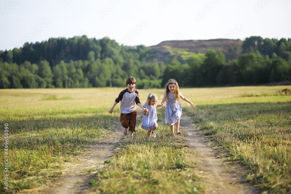 Children walk in the summer in nature. Child on a sunny spring morning in the park. Traveling with children.