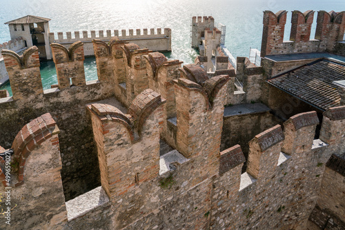 Fototapeta Medieval water castle of Sirmione on Garda Lake with battlement walls in high-an
