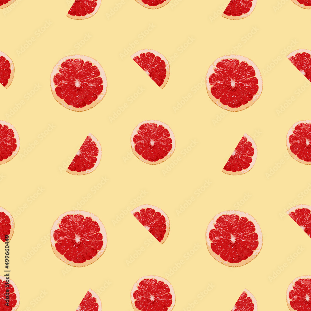 Seamless pattern of grapefruit slices on a yellow background. Can be used for pattern on fabric or packaging Seamless pattern of grapefruit slices on a yellow background. Can be used for pattern on fabric or packaging