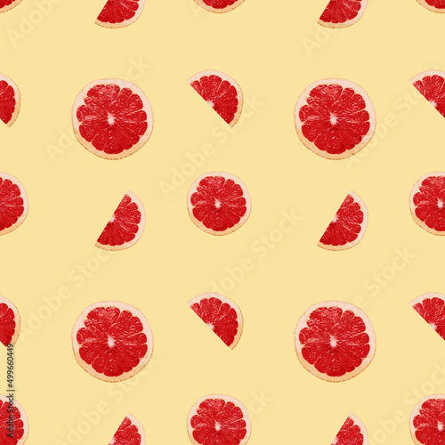 Seamless pattern of grapefruit slices on a yellow background. Can be used for pattern on fabric or packaging