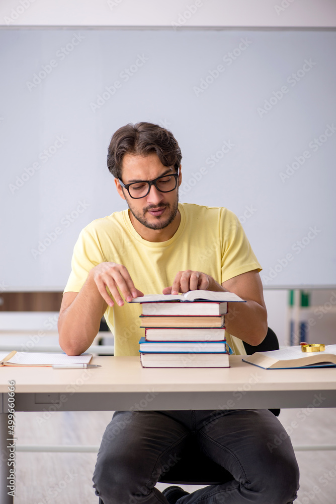 Young male student preparing for exams in the classroom Young male student preparing for exams in the classroom
