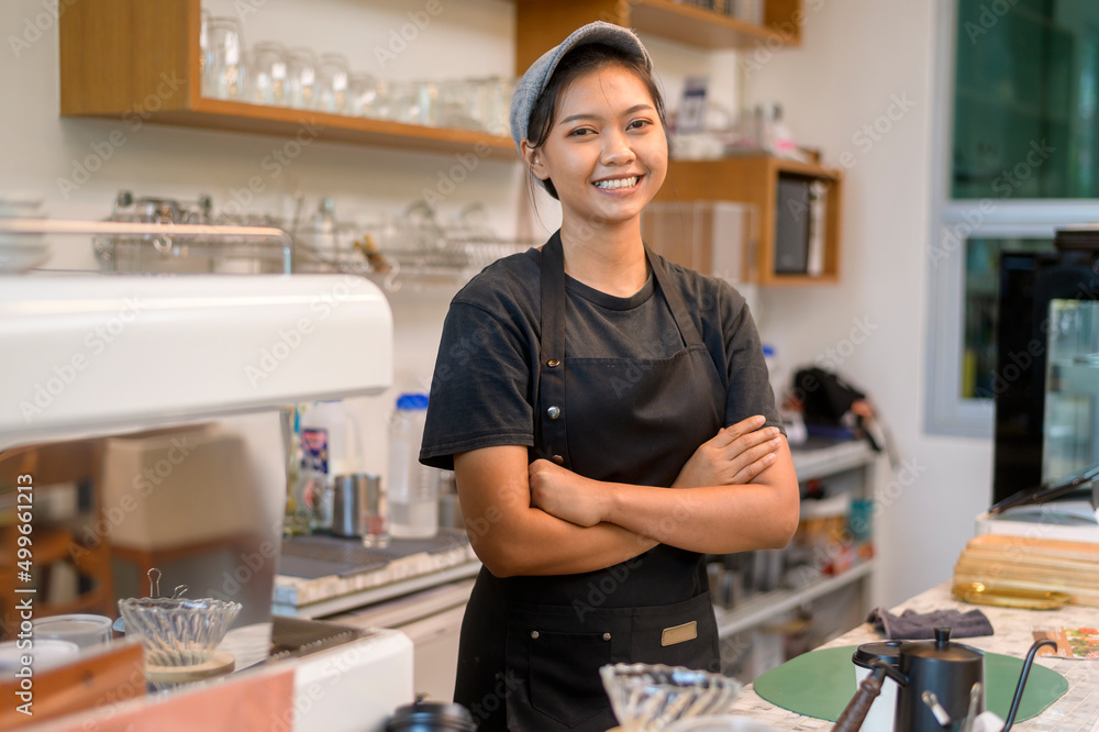 Young service minded barista woman working in coffee shop Young service minded barista woman working in coffee shop