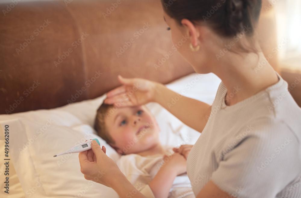 You definitely have a fever. Shot of a woman taking her little boys temperature with a thermometer in bed at home. - obrazy, fototapety, plakaty 