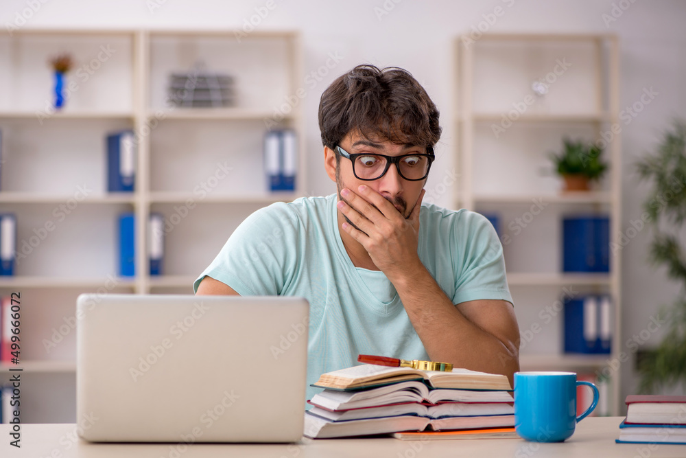 Young male student preparing for exams in the classroom Young male student preparing for exams in the classroom