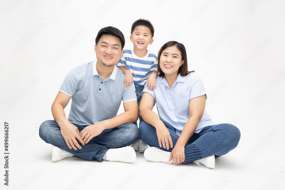 Asian family smiling and sitting together on floor isolated white background. Young thai family concept Asian family smiling and sitting together on floor isolated white background. Young thai family concept