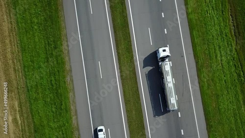 Isothermal Tank truck driving on highway. Oil and Gas Transportation and Logistics. Metal chrome cistern tanker with petrochemicals products. Liquid Chemical Freight. top view
