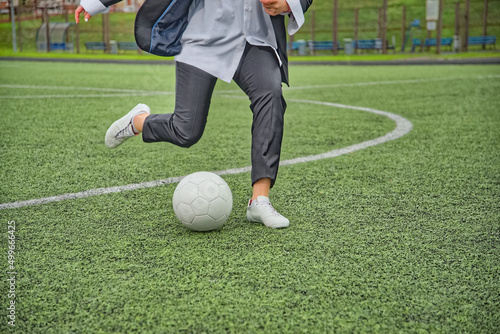 female soccer player kicking the ball in the stadium.