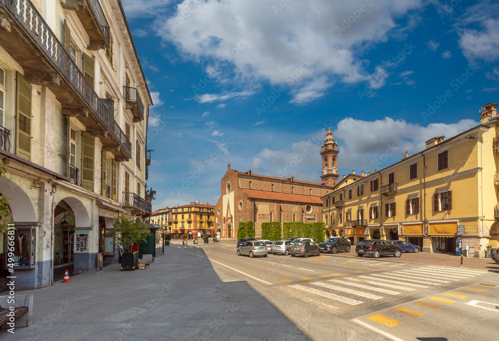 Saluzzo, Cuneo, Italy - April 15, 2022: Piazza Risorgimento with historic buildings and the Cathedral of the Assumption of the Virgin Mary